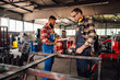 © Zamrznuti tonovi - Two craftsmen in a metal workshop getting ready for grinding material.
