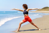 Fototapeta  - Fit woman doing yoga on beach