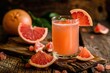 Glass of grapefruit juice with fresh fruit on wooden background
