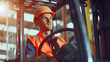 A Caucasian male employee is driving a forklift in a factory.