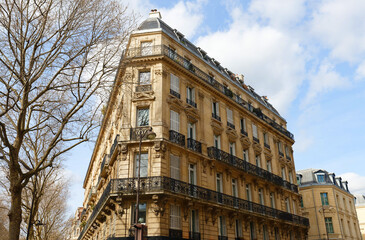 Wall Mural - The facade of traditional French house with typical balconies and windows. Paris.