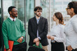 © qunica.com - A diverse group of young startup colleagues engage in a productive outdoor meeting in a city setting, exemplifying modern remote work.