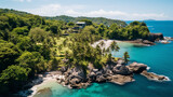 Fototapeta Krajobraz - Aerial view of a paradise beach or coves where the waves of the sea break on the rocks. Top view of a tropical coast with vegetation, few buildings, turquoise blue water on sunny day. Summertime.