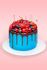 Wall Mural - Beautiful blue birthday cake decorated with fresh berries with a place for a label. The concept of summer desserts for a birthday
