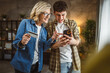 © Miljan Živković - mother and son woman young man shopping online at home use credit card