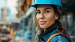 Close-up portrait of a woman engineer in a hard hat with a focused expression