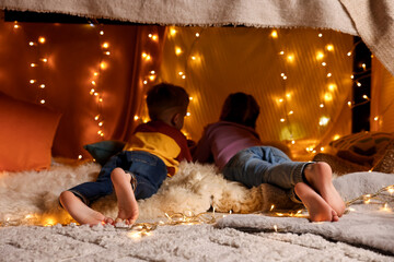 Poster - Kids in decorated play tent at home, back view