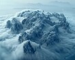 Majestic mountain range peeking through a sea of clouds in a breathtaking aerial view