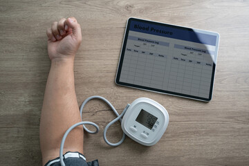 man using medical device to measure blood pressure patient in home top view