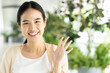 Happy, smiling, friendly asian woman in pointing up 5 fingers, concept image for number five, five points