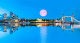 Fototapeta Londyn - Panorama of the Tower Bridge and Tower of London on Thames river at twilight blue hour - London, England