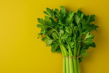 Wall Mural - Bunch of Celery on Yellow Background