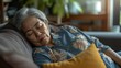 © lelechka - Senior asian woman sleep on sofa in living room during day. Sleep hour