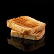 Fresh crispy toasted bread on a black background.