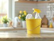 Bucket with cleaning items on wooden table against blurred kitchen background. Spring cleaning concept.