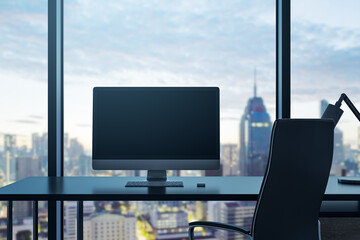 Fototapete - Clean office interior with empty computer monitor on desk and panoramic windows with beautiful city view and daylight. Mock up. Workplace concept. 3D Rendering.