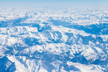 An aerial view of the Alps, a European mountain range and also the highest and most extensive mountain range that is entirely in Europe, stretching approximately 1,200 km across eight Alpine countries