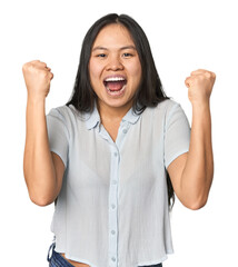 Wall Mural - Young chinese woman isolated cheering carefree and excited. Victory concept.