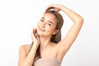 © Shutter B - Happy beautiful young asian woman smile touching her face on white background, clean fresh bare skin concept. Facial treatment, Perfect skin, Natural make up.