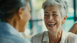 © VK Studio - Two senior women laughing heartily in a bright, friendly conversation at a café.