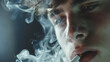 A young man smoking cigarette, exhales cigarette smoke. Enjoyable activity and nicotine addiction.