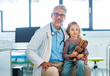 Portrait of a pediatrician with a little patient sitting on his knee. Friendly relationship between the doctor and child patient.