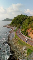 Wall Mural - car driving on curved road in Thailand. road landscape in summer. drive on the beachside highway. Chantaburi Province Thailand, Road along the beach and ocean, Chalerm Burapha Chonlathit Highway
