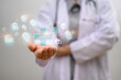 © Prathankarnpap - Doctor holding holding blue virtual plus sign. Health insurance and medical check up concept