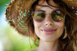 Closeup portrait of smiling Woman in Straw Hat and Sunglasses