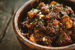 Beef stewed with potatoes and herbs in a clay bowl