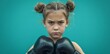 Young girl wearing boxing gloves posing confidently against a vibrant blue background, showing strength and determination