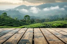 A Wooden Table Placed In Front Of A Sprawling Tea Plantation, Offering A Scenic View Of Lush Greenery And Tea Bushes