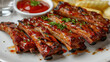 a white plate topped with grilled pork ribs and ketchup