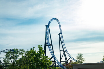 Wall Mural - Empty ride roller coaster on sky background in amusement park