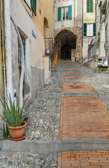 Wall Mural - Typical uphill alley of the medieval town, called 