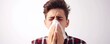 Unhealthy sick man sneezing in to tissue on white background. allergy sneezing concept. banner