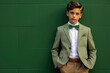 Dressed to impress, the kid model stands confidently against a solid green wall, his attire and demeanor reflecting timeless elegance and style.
