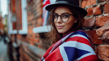 Beautiful Woman On The Brick Wall Background With The British Flag On Her Shoulders