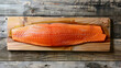 Whole piece of fresh salmon on a wooden table. Fresh food samples.
