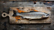 Salmon on a wooden cutting board, on a wooden table with a top down view. Fresh food background.