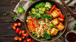Vegetarian cuisine with bowls of noodles, fried tofu and vegetables on a wooden table. Food sample.