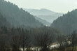 Mystery view of the Dunajec River Gorge and the Monastery Mountain shrouded in fog and sun in Pieniny National Park