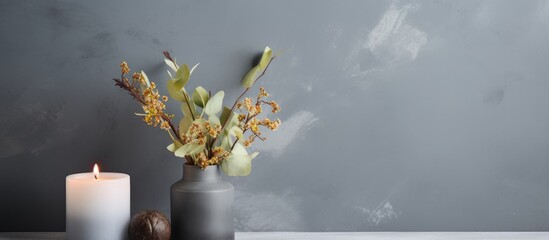 Canvas Print - A beautiful vase containing colorful flowers and a softly flickering candle rests on a table, creating a tranquil ambiance in the room