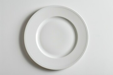 Poster - A simple white plate on a clean white table. Suitable for various food and kitchen concepts