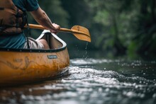 A Man Paddling A Canoe Down A River. Suitable For Outdoor Activities Concept