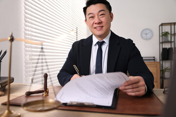 Wall Mural - Happy notary writing notes at wooden table in office