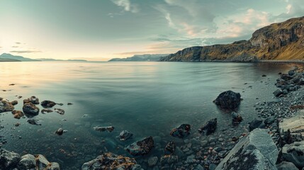 Poster - Scenic view of a body of water with rocks and a majestic mountain in the background. Ideal for travel and nature concepts