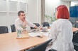 © Oscar - young working couple at a brainstorming meeting. business in a coworking room