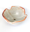 The ceramic cup has been adapted for planting small pot plants