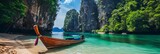 Fototapeta Natura - Idyllic tropical beach with a longtail boat - Pristine Thai beach with a traditional longtail boat floating near the cliff-lined shores of a serene emerald sea